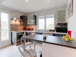 a kitchen with a table with a bowl of fruit on it at Apartment Les Gentianes by Interhome in Saint-Gervais-les-Bains