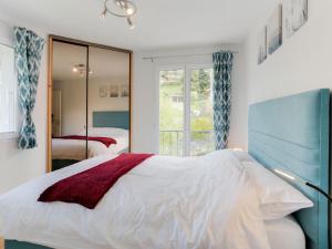 a bedroom with a white bed and a window at Apartment Les Gentianes by Interhome in Saint-Gervais-les-Bains