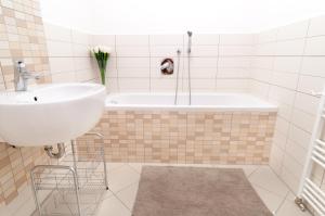 a bathroom with a sink and a bath tub at Modern Apartment - Prague Centre in Prague