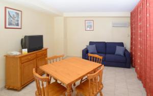 
a living room filled with furniture and a tv at Apartamentos Avenida in Benidorm
