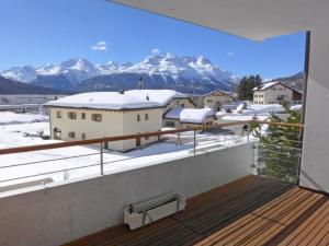 a balcony with a view of snow covered mountains at Apartment Chesa Sur Puoz 7 by Interhome in Samedan