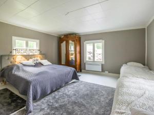 a bedroom with two beds and two windows at Holiday Home Villa nennebo by Interhome in Förby