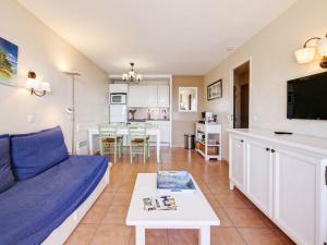 a living room with a couch and a table at Apartment Les Rivages de Coudoulière-29 by Interhome in Six-Fours-les-Plages