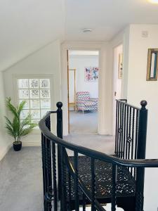a staircase leading to a living room with a couch at The Old Queens Stable on Sea in Hollington