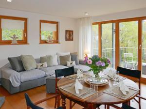 a living room with a couch and a table at Apartment Chesa San Bastiaun B4 by Interhome in Samedan +22 photos