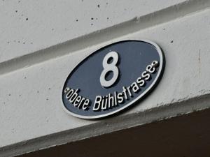 un panneau sur le côté d'un bâtiment dans l'établissement Apartment Chalet Waldchutz - 2- Stock by Interhome, à Lenk im Simmental