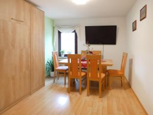 a dining room with a table and chairs and a television at Apartment Petra-2 by Interhome in Frankenhain +16 photos