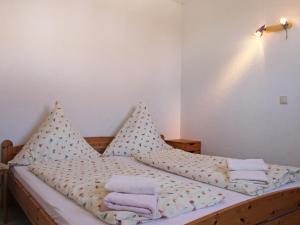 a bed with polka dot sheets and towels on it at Apartment FIP-Ferienpark - Insel Poel-1 by Interhome in Gollwitz