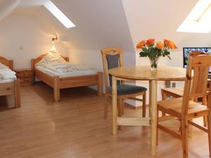 a room with a table and chairs and a bed at Apartment Gollwitzer Park - Insel Poel-5 by Interhome in Gollwitz