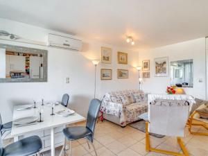 a living room with a bed and a table and chairs at Apartment Les Quais de L'Amirauté-7 by Interhome in Saint Cyprien Plage