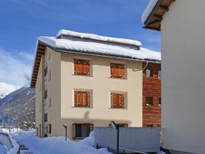 a building with snow on the roof at Apartment Chesa San Bastiaun B5 by Interhome in Samedan