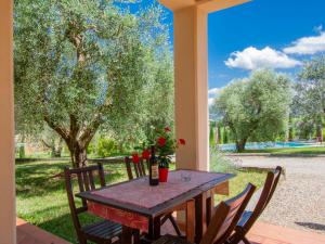 a table and chairs on a porch with a view at Holiday Home Borgo Fontana-10 by Interhome in Cerreto Guidi
