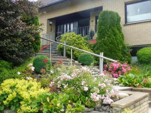 a garden of flowers in front of a house at Apartment Waldvogt by Interhome in Lothe