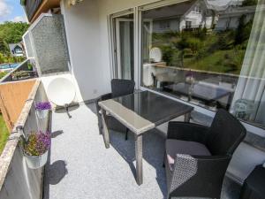 a patio with a table and chairs on a balcony at Studio Cala-2 by Interhome in Stryck