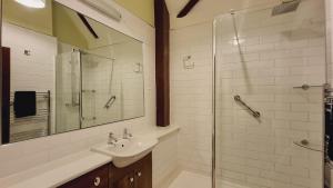 a bathroom with a sink and a glass shower at River Nene Cottages in Water Newton