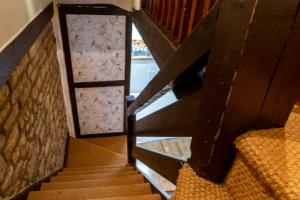 a set of stairs with a door and a window at River Nene Cottages in Water Newton