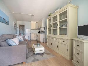 a living room with a couch and a tv at Apartment Port Arcachon-3 by Interhome in Arcachon +19 photos