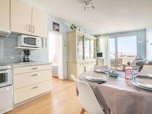 a kitchen and dining room with a table and chairs at Apartment Port Arcachon-3 by Interhome in Arcachon