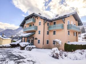 a large apartment building with snow on the ground at Apartment Parc du Mont Joly-3 by Interhome in Saint-Gervais-les-Bains