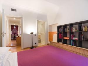 a bedroom with a purple rug and a book shelf at Apartment Regina Ottavia by Interhome in Rome
