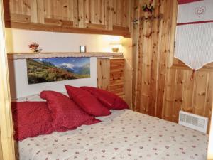 a bedroom with a bed with red pillows at Apartment Les Jardins Alpins-9 by Interhome in Saint-Gervais-les-Bains