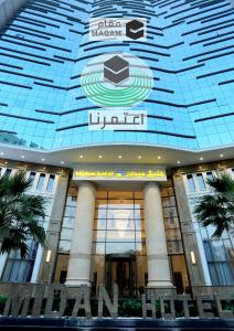 a large building with a sign on top of it at Midan Hotel & Suites Al Aziziya in Makkah