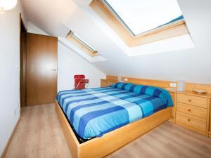a bedroom with a bed and a skylight at Apartment Enrosadira-7 by Interhome in Alba di Canazei