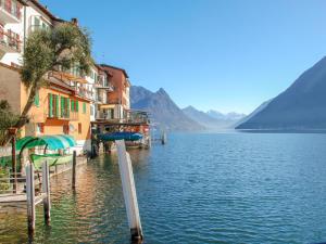 a view of a body of water next to buildings at Apartment Al Puntil by Interhome in Gandria