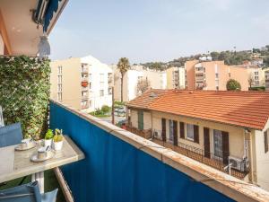 a balcony with a blue fence and a building at Apartment L'Amiral-1 by Interhome in Cagnes-sur-Mer