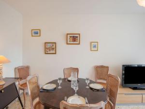 a dining room with a table with chairs and a tv at Apartment L'Amiral-1 by Interhome in Cagnes-sur-Mer +19 photos