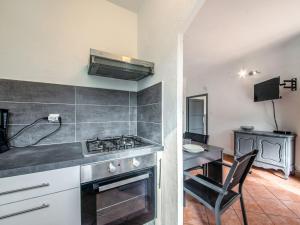 uma cozinha com um fogão e uma cadeira num quarto em Apartment Le Narcisse by Interhome em Cagnes-sur-Mer
