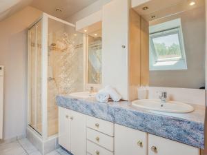 a bathroom with two sinks and a shower at Holiday Home Coët A Tous by Interhome in Carnac +18 photos