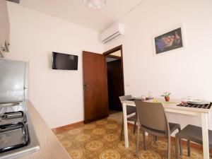 a small kitchen with a table and chairs in a room at Apartment Fiori di Sulla SinAgo by Interhome in Lascari +8 photos