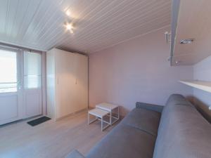 a living room with a couch and a table at Apartment Empaja great views and parking by Interhome in De Haan