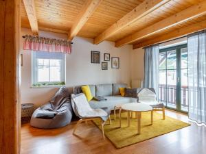 a living room with a couch and a table at Holiday Home Holiday Hill 67 by Interhome in Lauterwasser +60 photos