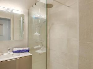 a bathroom with a glass shower and a sink at Studio Le Mexico-8 by Interhome in Saint-Raphaël