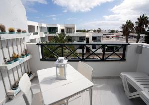 コスタ・テギセにあるSea Breeze Apartment 309の白いバルコニー(白いテーブルと椅子付)