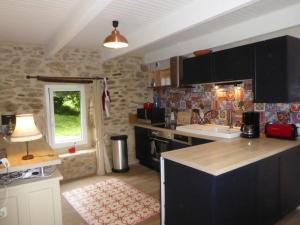 a kitchen with a sink and a counter top at penty breton in Pouldreuzic
