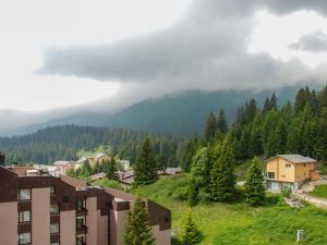 een stad op een heuvel met bomen en een berg bij Apartment Albarella Panorama by Interhome in San Bernardino