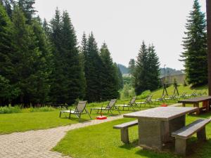 a group of picnic tables and chairs in a park at Apartment Albarella Panorama by Interhome in San Bernardino