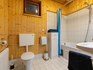 a bathroom with a toilet and a sink and a tub at Apartment Pistenblick-3 by Interhome in Hochrindl