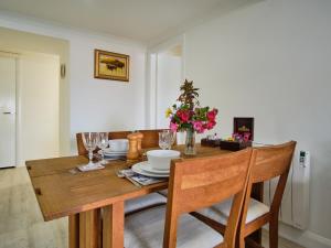 a dining room table with chairs and flowers on it at Apartment Imperial Apartment by Interhome in Oban +12 photos