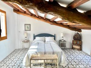 A bed or beds in a room at Casa Rural El Molí - Penáguila