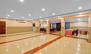 a banquet hall with a table and a dining room at Treebo Trend The Pearl Bliss in Patna