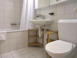 a bathroom with a toilet and a sink and a tub at Apartment Chesa Ginellas by Interhome in Sils Maria