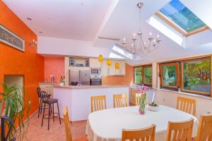 a kitchen and dining room with a table and chairs at Holiday Home Ana's Paradise in Mlini