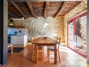 cocina y comedor con mesa de madera y sillas en Holiday Home Tio Pepe de Maja by Interhome, en Godall