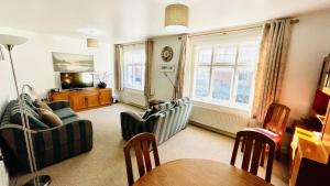 a living room with a couch and chairs and a table at Bayards - Pet Friendly, Central Dartmouth in Dartmouth