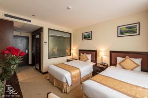 Ένα ή περισσότερα κρεβάτια σε δωμάτιο στο Red River View Hotel