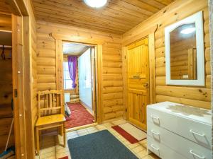 a log cabin bathroom with a sink and a toilet at Holiday Home Ukkohovi 4 paritalo by Interhome in Hyrynsalmi